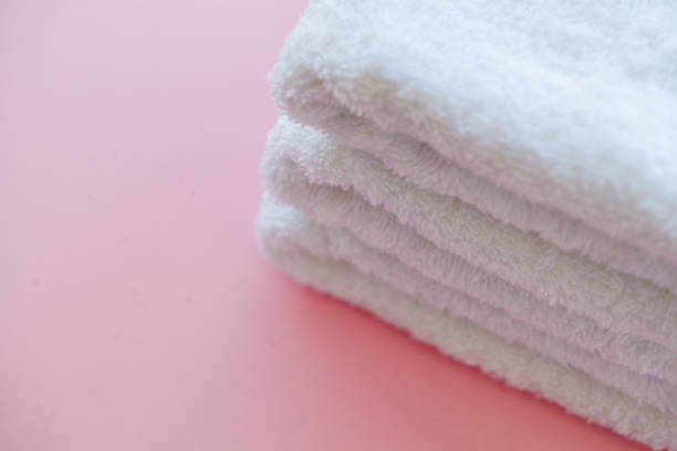 istock Beautiful Spa Composition White Towels on Pink Table 1091872172