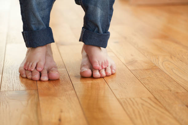 istock Child standing barefoot on his father's feet 1091872998
