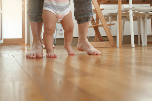 istock Father teaching baby to walk 1091873014