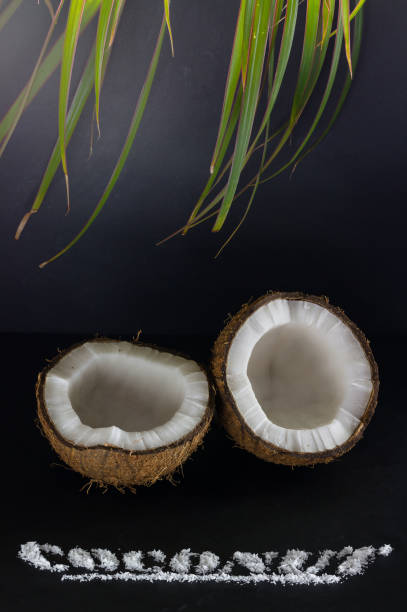 Ripe coconut split into two parts close-up