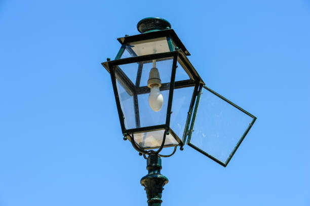 istock Isolated old vintage lamppost against a blue sky. 1091877700