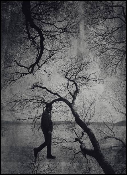 istock Monochrome multiple exposure of a man walking and trees 1091877714