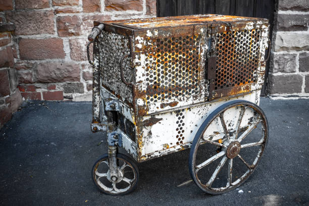 Old rusty vintage animal cage on wheels