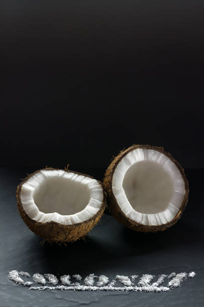 Ripe coconut split into two parts close-up