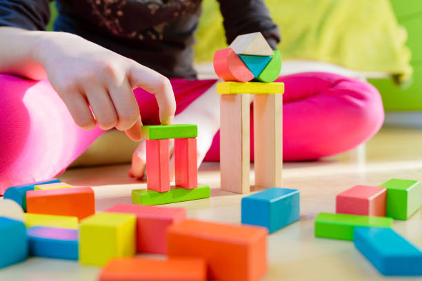 istock child playing with colorful wooden blocks 1091883302