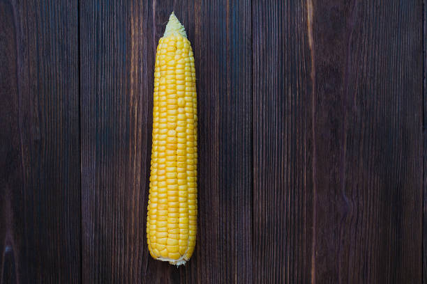 istock Grains of ripe corn on wooden background 1091885878