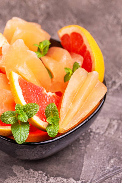 istock Homemade grapefruit popsicle with ripe grapefruit slices and fresh mint on dark concrete background 1091888842