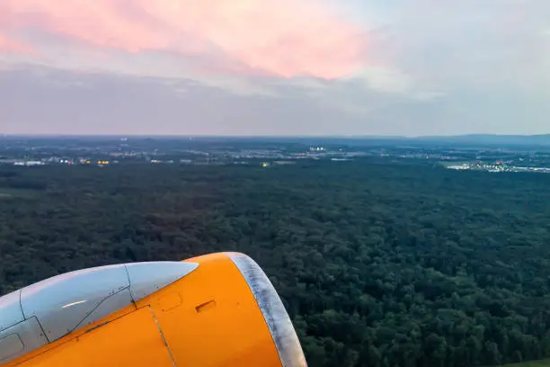 Dulles, USA International Airport, IAD, countryside with colorful pink red sunset in Virginia evening night, buildings illuminated, airplane yellow engine