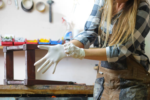 women putting on protective gloves - restoring art painting artist imagens e fotografias de stock