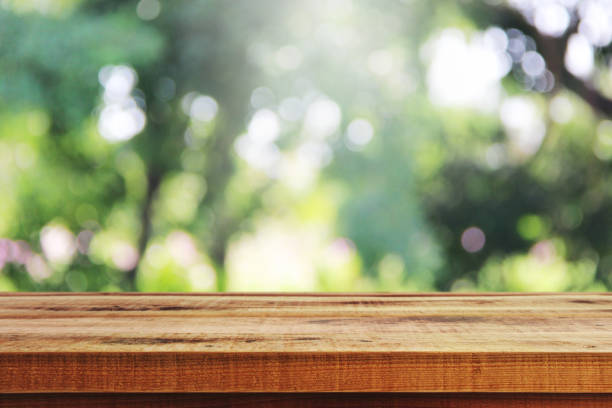 istock Wooden table and blurred green garden background. 1091894850