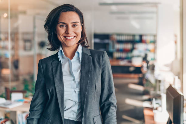 Portrait of a smiling businesswoman Portrait of a smiling young businesswoman in the office well dressed photos stock pictures, royalty-free photos & images
