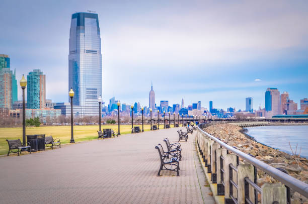 New Jersey city in front of Manhattan New York City, Manhattan Midtown skyline and Jersey City skyline with  skyscrapers from the Liberty State park just in front of the Ellis Island. jersey city stock pictures, royalty-free photos & images