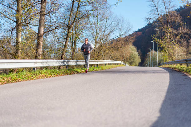 Young athlete jogging on a suburb road