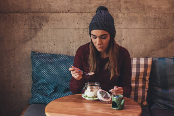 istock Cute girl enjoys her breakfast at cafe 1091897592