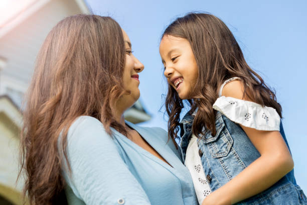 istock Mother holds daughter outside home 1091903300