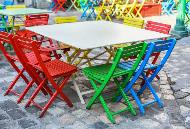 Colorful tables and chairs of empty outdoor cafe in Italy