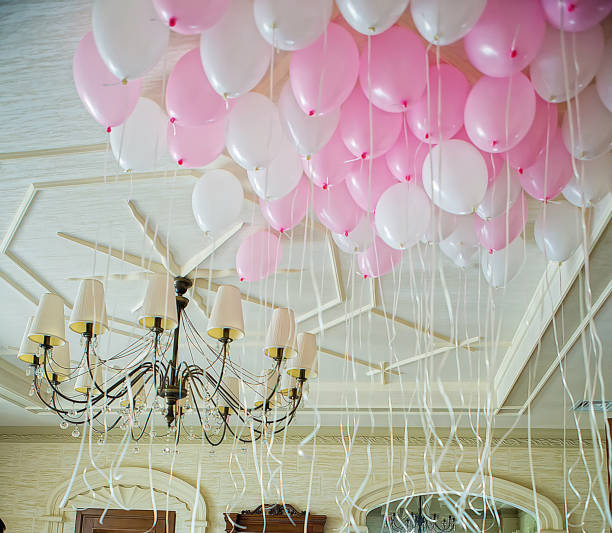 istock Pink and white balloons floating in the room 1091907774