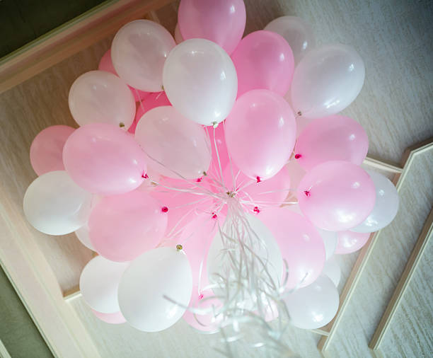 istock Pink and white balloons floating in the room 1091907796