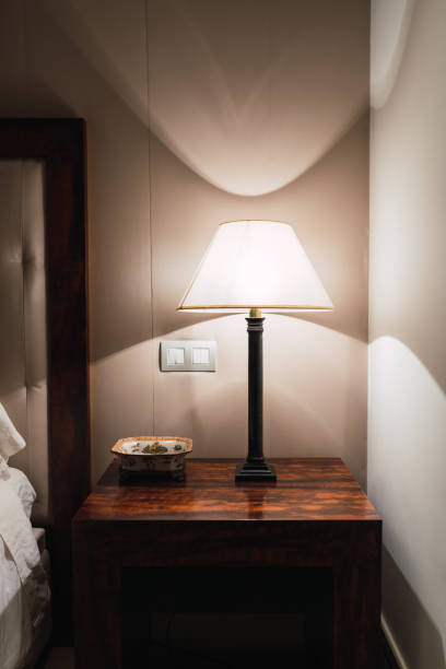 istock Burning lamp on wooden table in bedroom 1091908076