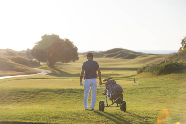 istock Golf player is turning back after game finished - links golf 1091910360