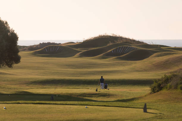 istock Golf player is turning back after game finished - links golf 1091910608