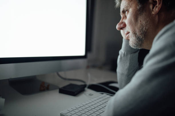 istock Mature man sitting at the office late at night 1091912134