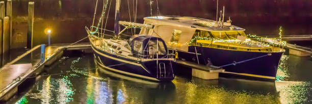 istock two docked boats in the harbor decorated with lights 1091912550