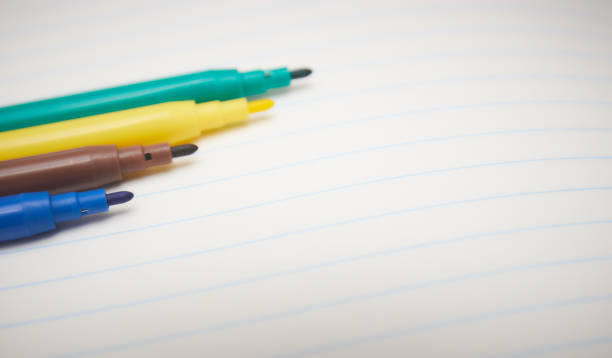 istock four colored markers on a white Notepad background, close-up, copy space. place for text. school topics. study concept. 1091912856