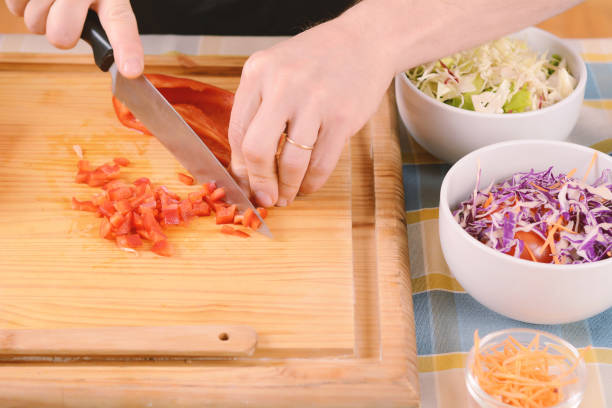 istock Close up of man cutting vegetables on the board 1091919814