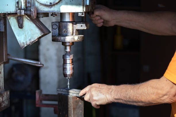 istock A male worker operating an industrial drill machine inside an aluminium factory. 1091922436