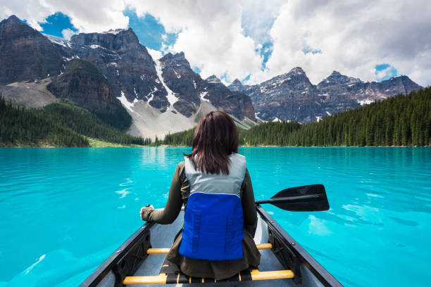 touristischen kanufahren auf moraine lake, banff nationalpark, alberta, kanada - kayak canoeing canoe lake stock-fotos und bilder