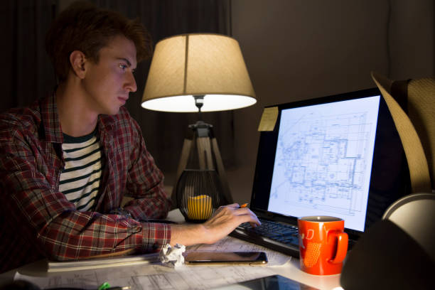 istock Young mid age man working late in home office 1091924162