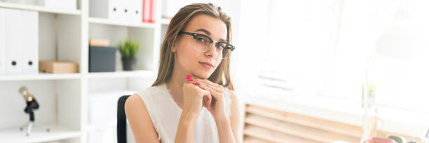 istock Young girl in the office sits at the table. On the table are documents. 1091934874