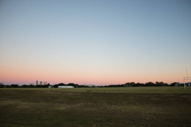 istock sunset over a field pink sky ground 1091935500