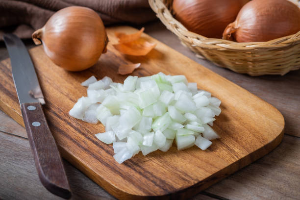 istock Fresh chopped onions on wooden cutting board 1091935506