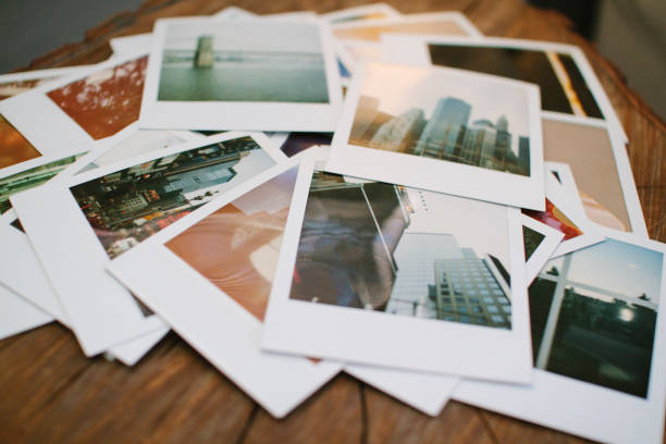 istock Pile of Polaroids on Wood Surface 1091937606