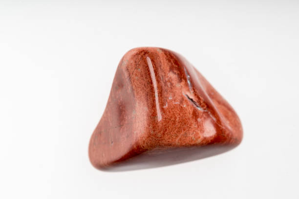 istock Red jasper mineral stone sample with white background 1091940946