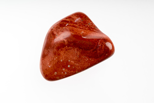 Red jasper mineral stone sample with white background
