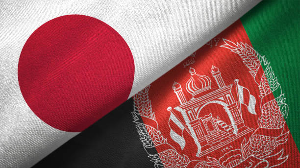 istock Afghanistan and Japan two flags textile cloth fabric texture 1091944290