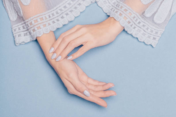 beautiful hands with blue nails on a blue background