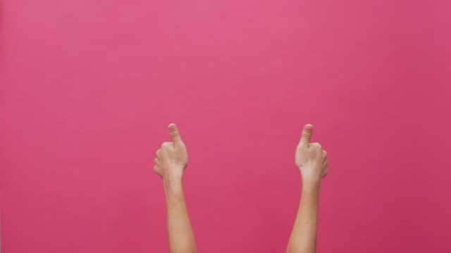 Woman thumb up on isolated pink background 4k