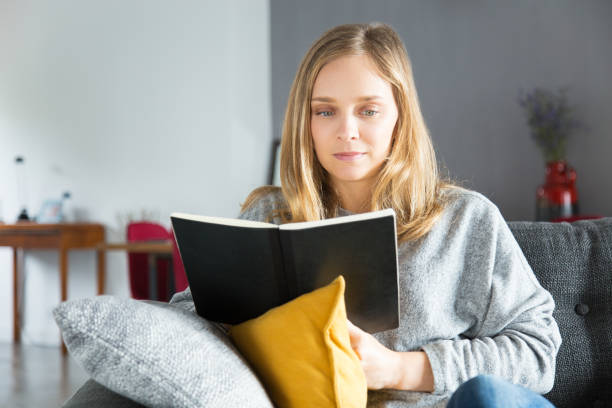 istock Serious housewife reading book 1092000992