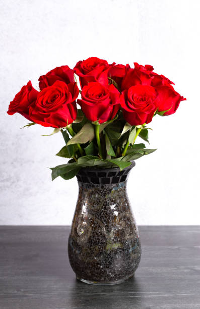 istock A Dozen Red Roses in a Vase on a Wooden Table 1092007520