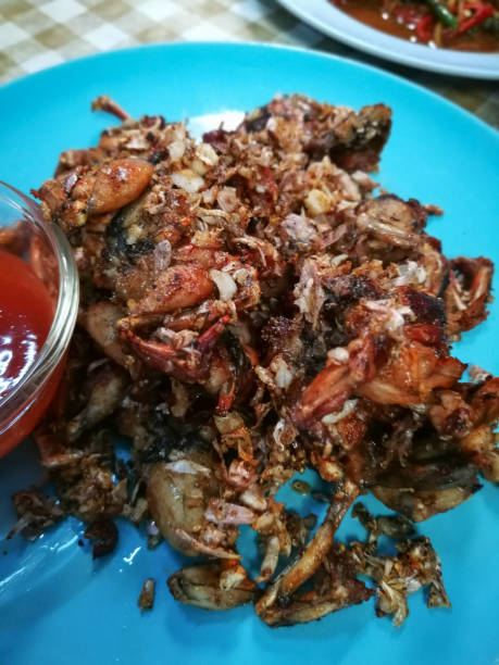 istock Fried Frogs with Salt and Black Pepper. on blue plate 1092009572