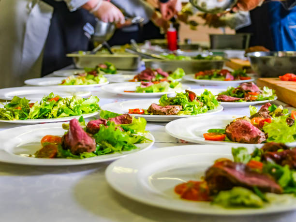 istock Cooked Roast Beef, Fresh Salad And Tomatoes Served On White Plates. Cooking Master Class, Workshop with People Learning How to Cook Around the Table 1092012760