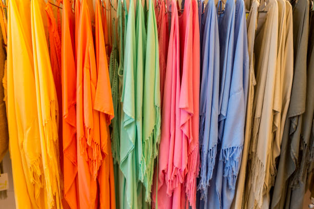 fashion clothes on clothing rack - bright colorful closet. close-up of rainbow color choice of trendy female wear on hangers in store closet or spring cleaning concept. summer home wardrobe. - 13585 imagens e fotografias de stock