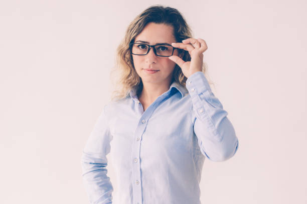 istock Serious confident businesswoman adjusting glasses 1092016736