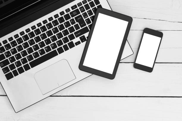 istock Laptop, smartphone and digital tablet on a white wooden table. 1092021798