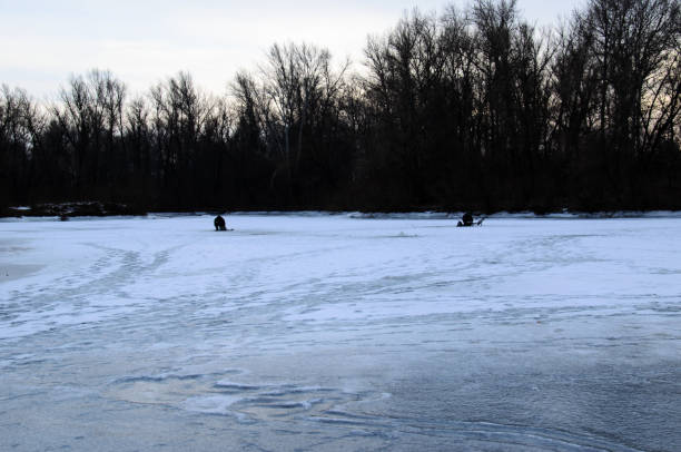 istock Winter fishing on a frozen river 1092031730