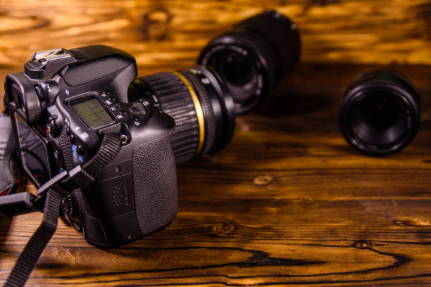 istock Modern dslr camera and lenses on wooden table 1092031862